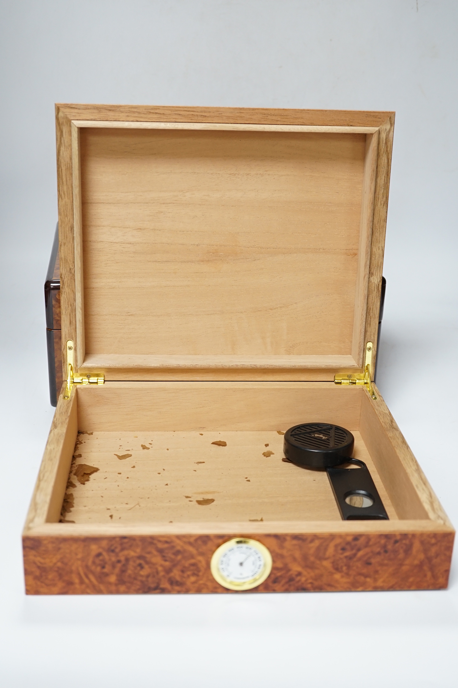 Two burr wood humidors, one with contents including Cohiba